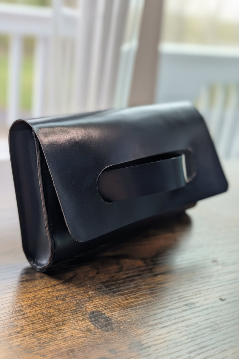 Blue leather clutch purse on a wooden surface